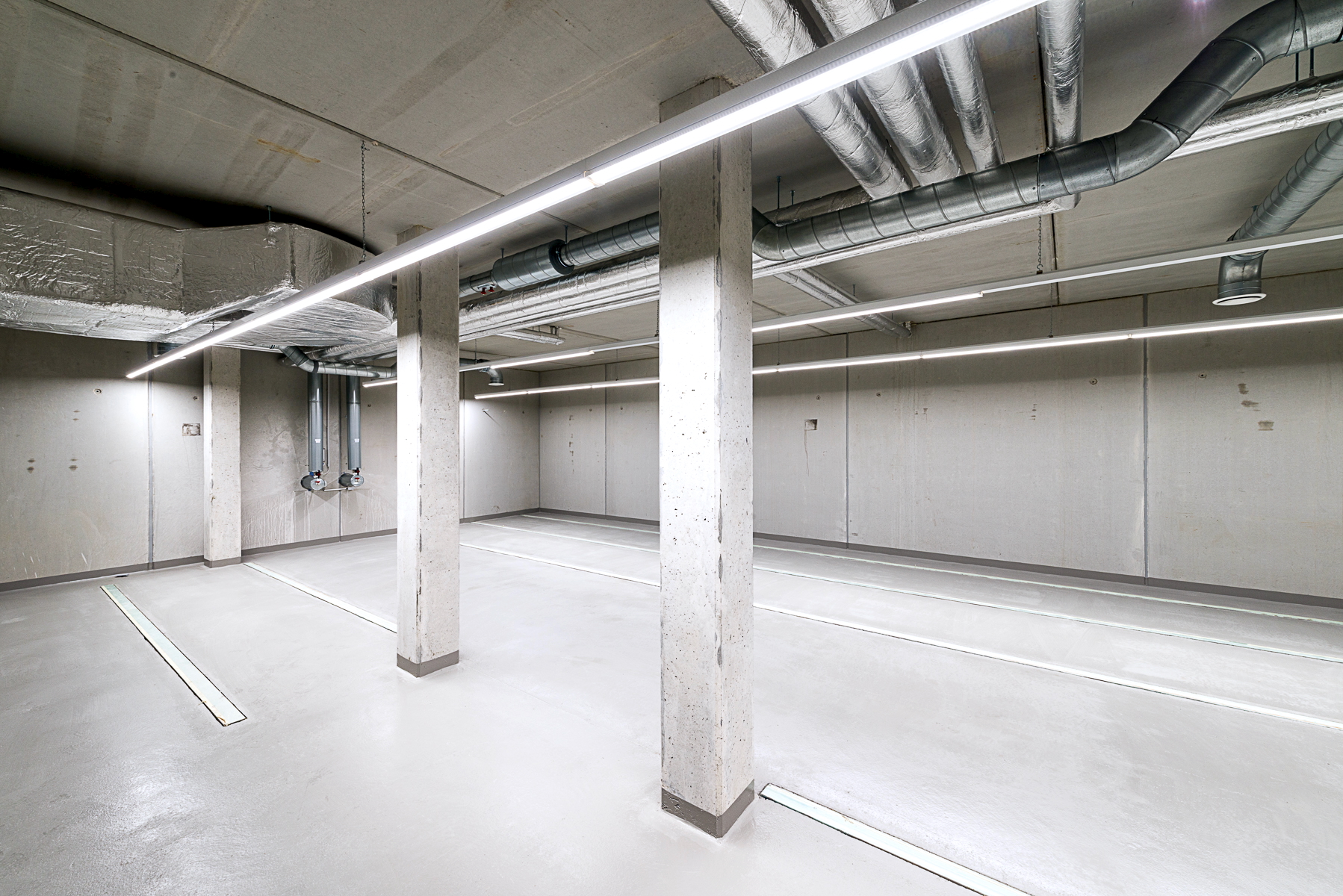 Archivraum im Kellergeschoss des Finanzamts Waldmünchen, Außenstelle des Finanzamts Erlangen, ohne Rollregale mit sichtbarer technischer Installation im Deckenbereich.
